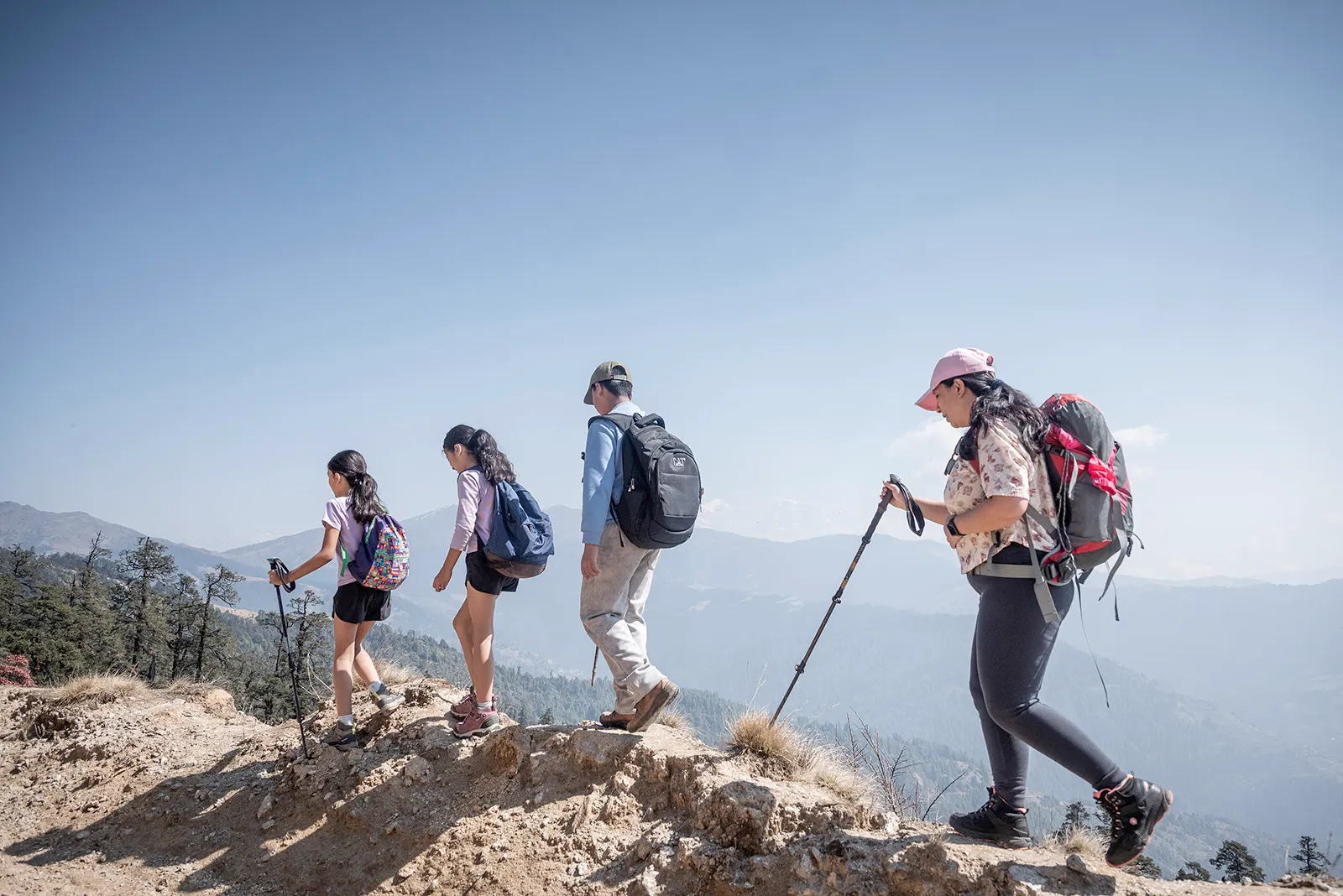 Family hiking toward Pikey Peak with beautiful mountain views and alpine landscapes in Nepal.