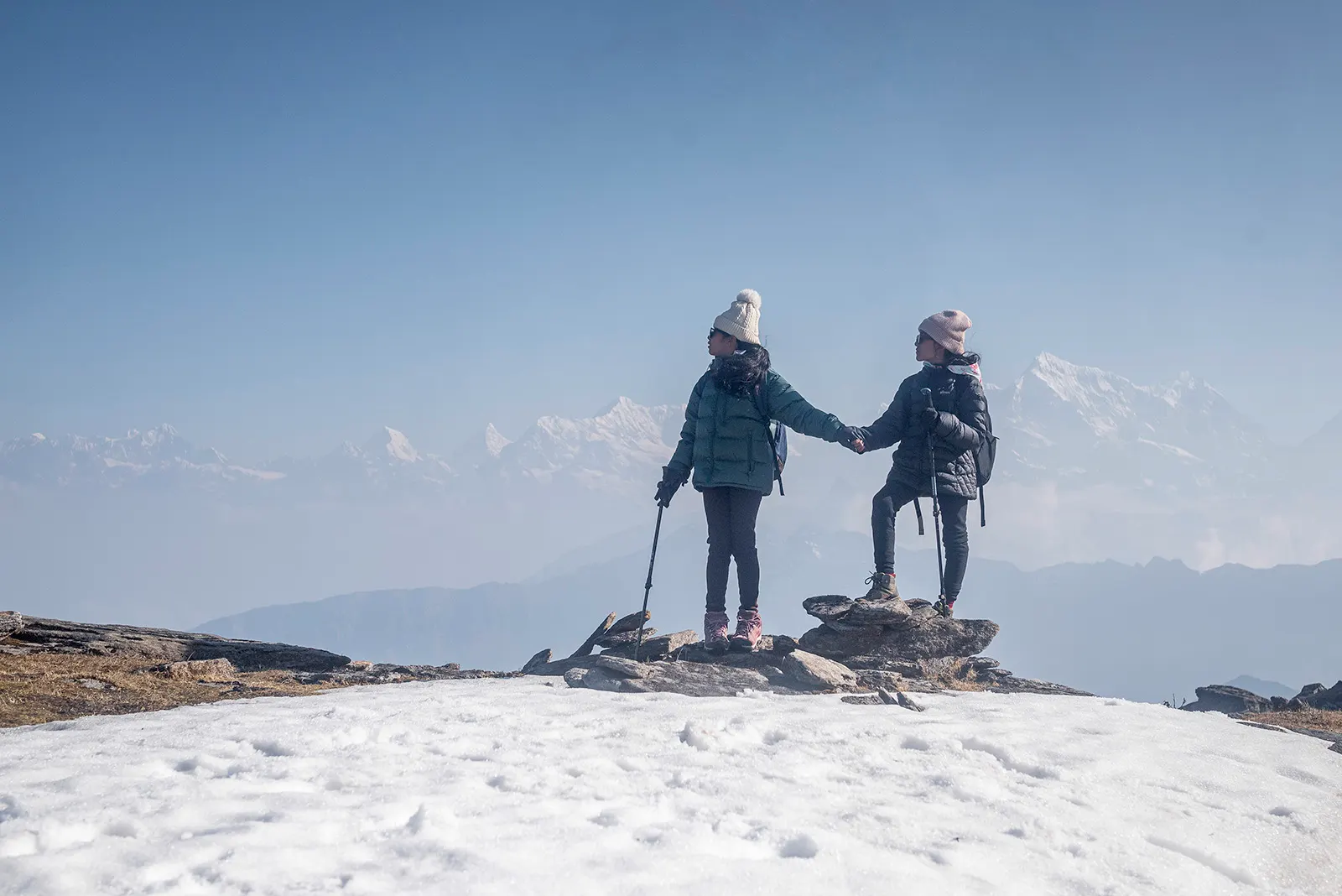 Little girls posing with the majestic Himalayan mountains in the background.