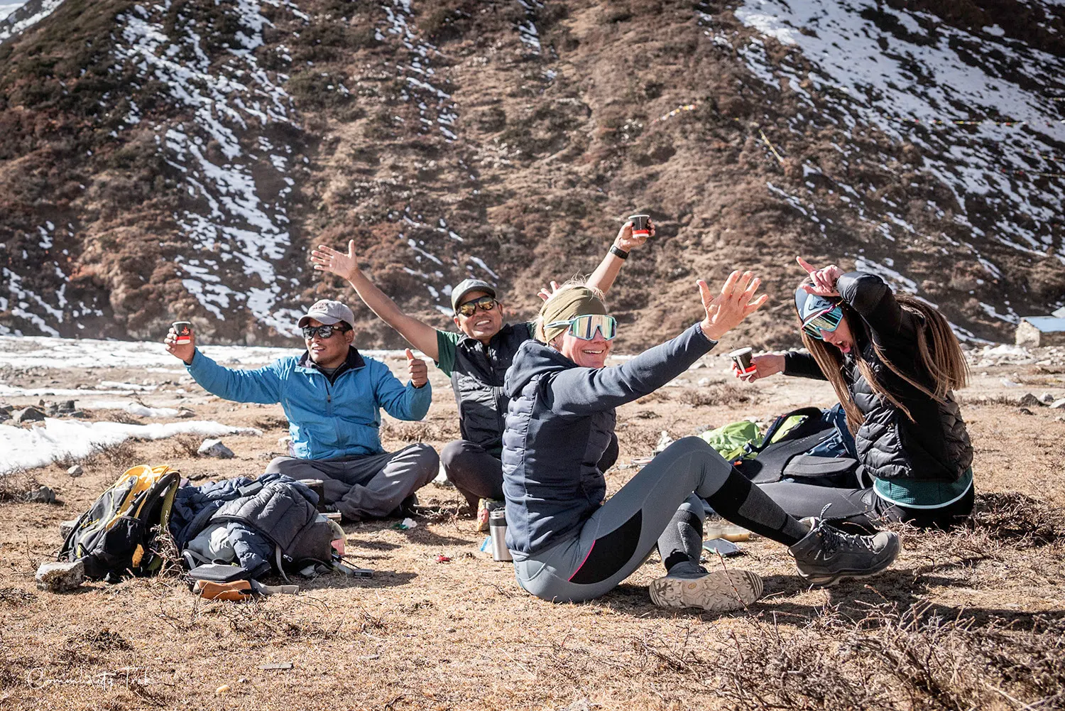 Trekker sitting beneath Mount Manaslu beside Birendra Lake in Nepal