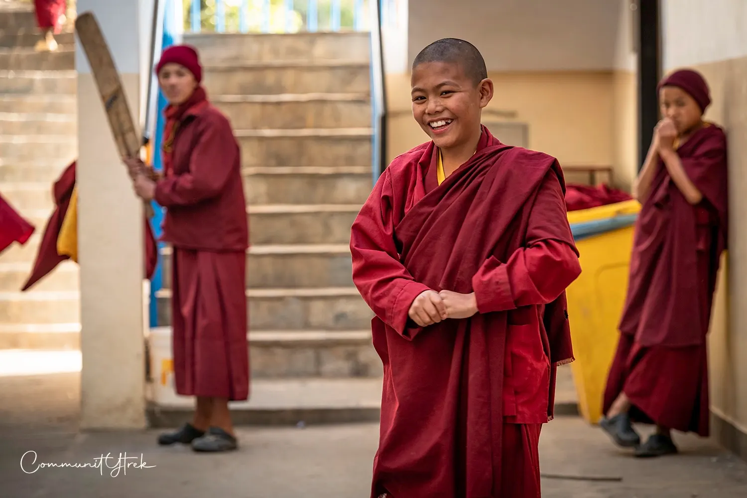 Young Buddhist monks happily playing cricket in their free time at Namo Buddha Monastery