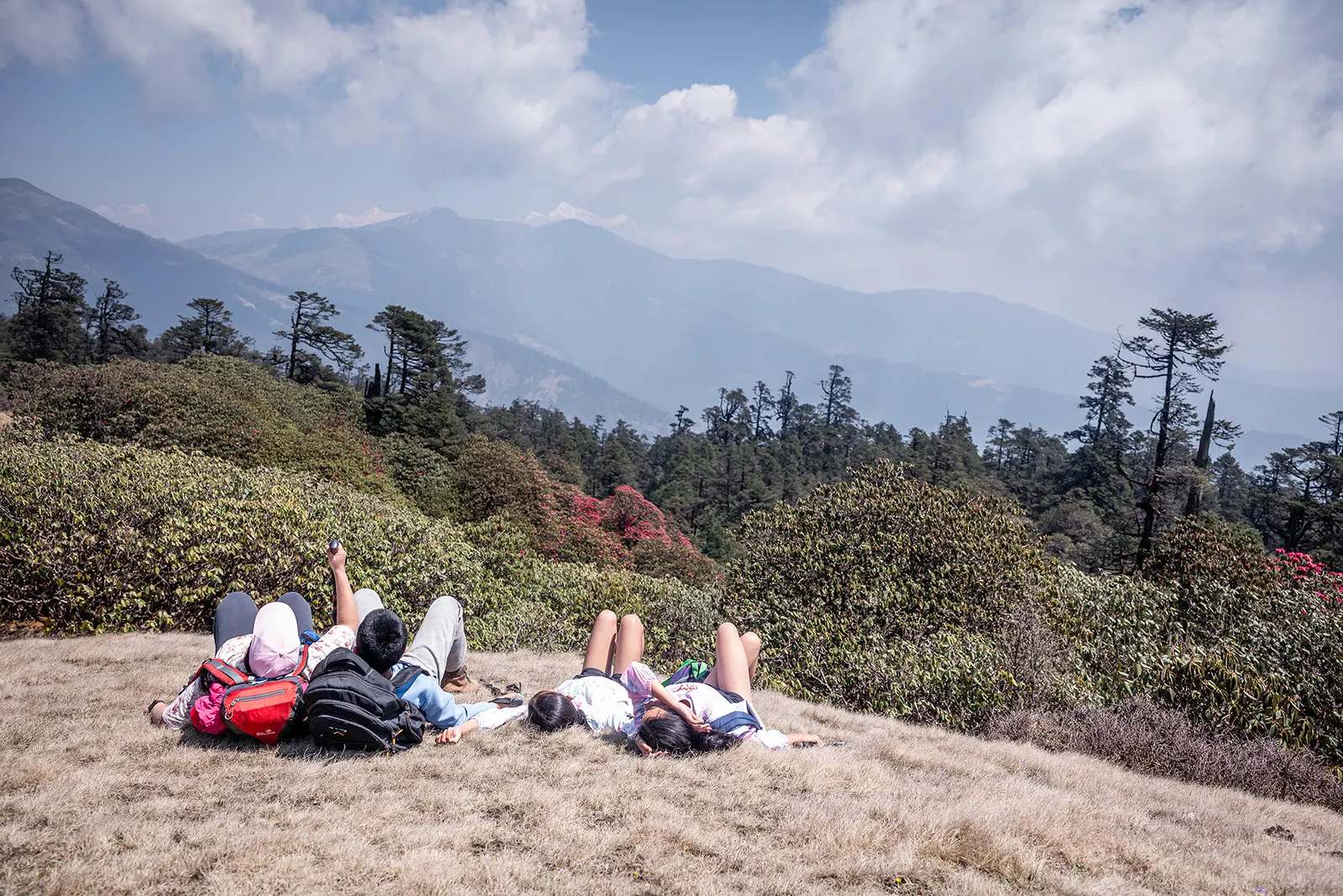 Relaxing on a peaceful mountain meadow surrounded by the stunning Himalayan landscape